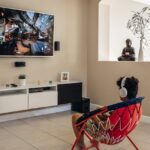 a young man wearing headphones watching tv