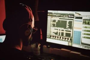 a man in a dark room looking at a brightly lit display on a desktop setting up digital privacy