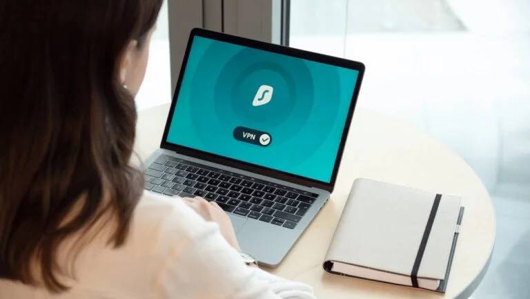 a woman looking at her laptop screen that has vpn on it